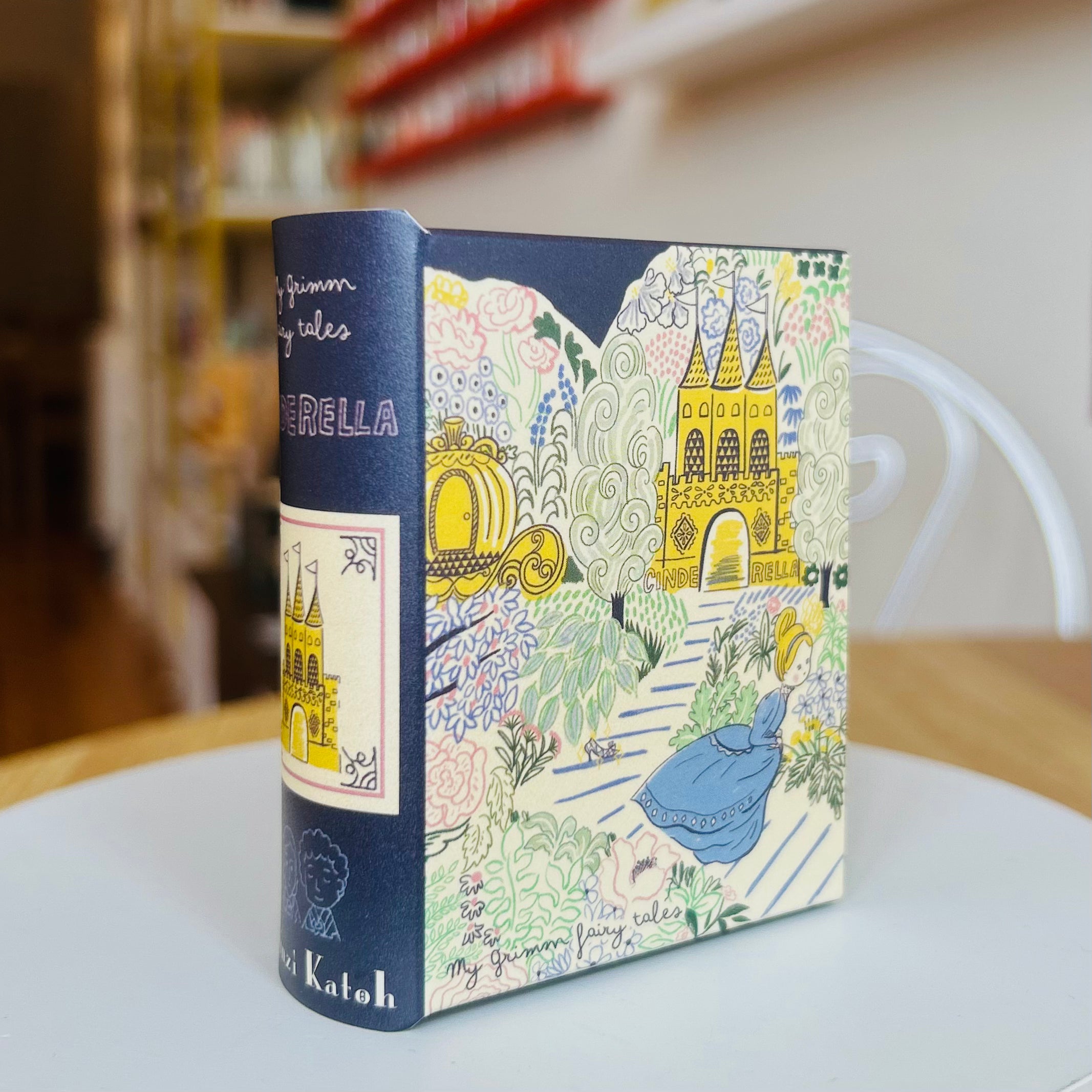 Book style case with colorful cover featuring Cinderella and fairy tale scene on a table