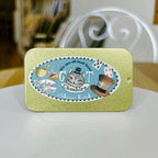 Decorative tin with Cheshire Cat design on a white surface